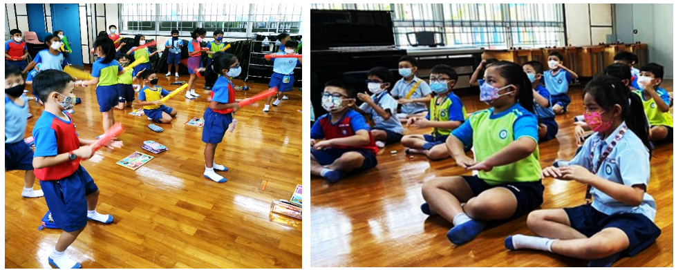 Children wearing masks play with colorful sticks and sit on a wooden gym floor in two indoor school activity scenes.